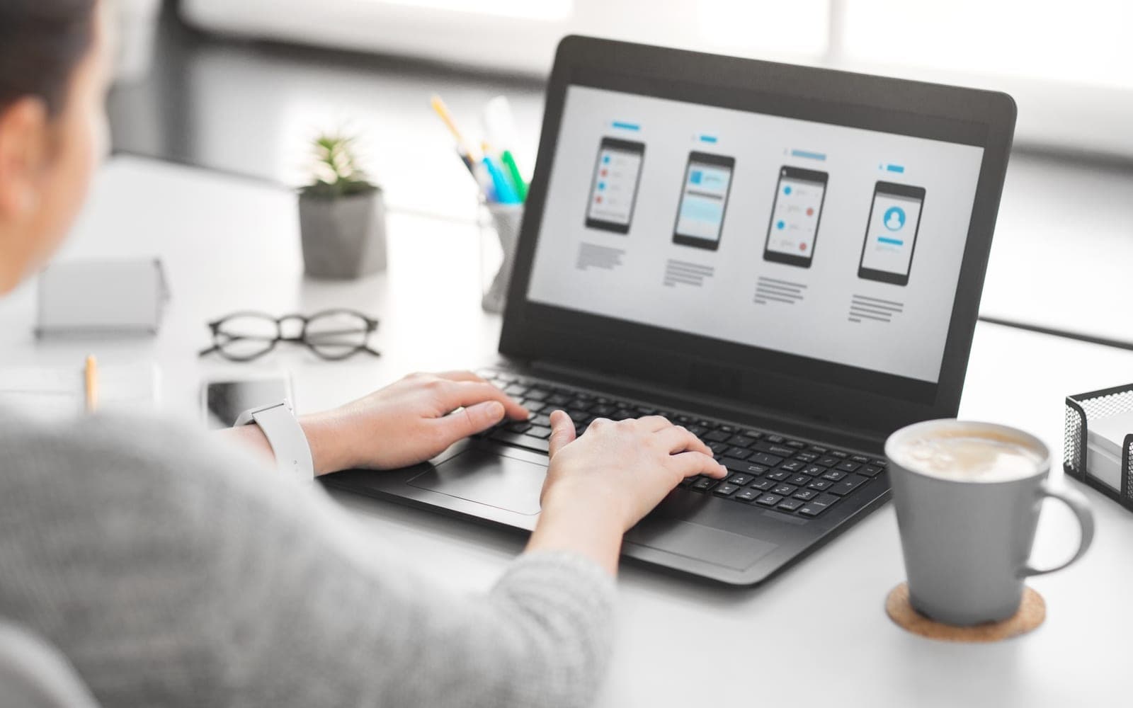 A web designer building and structuring a website layout on a computer