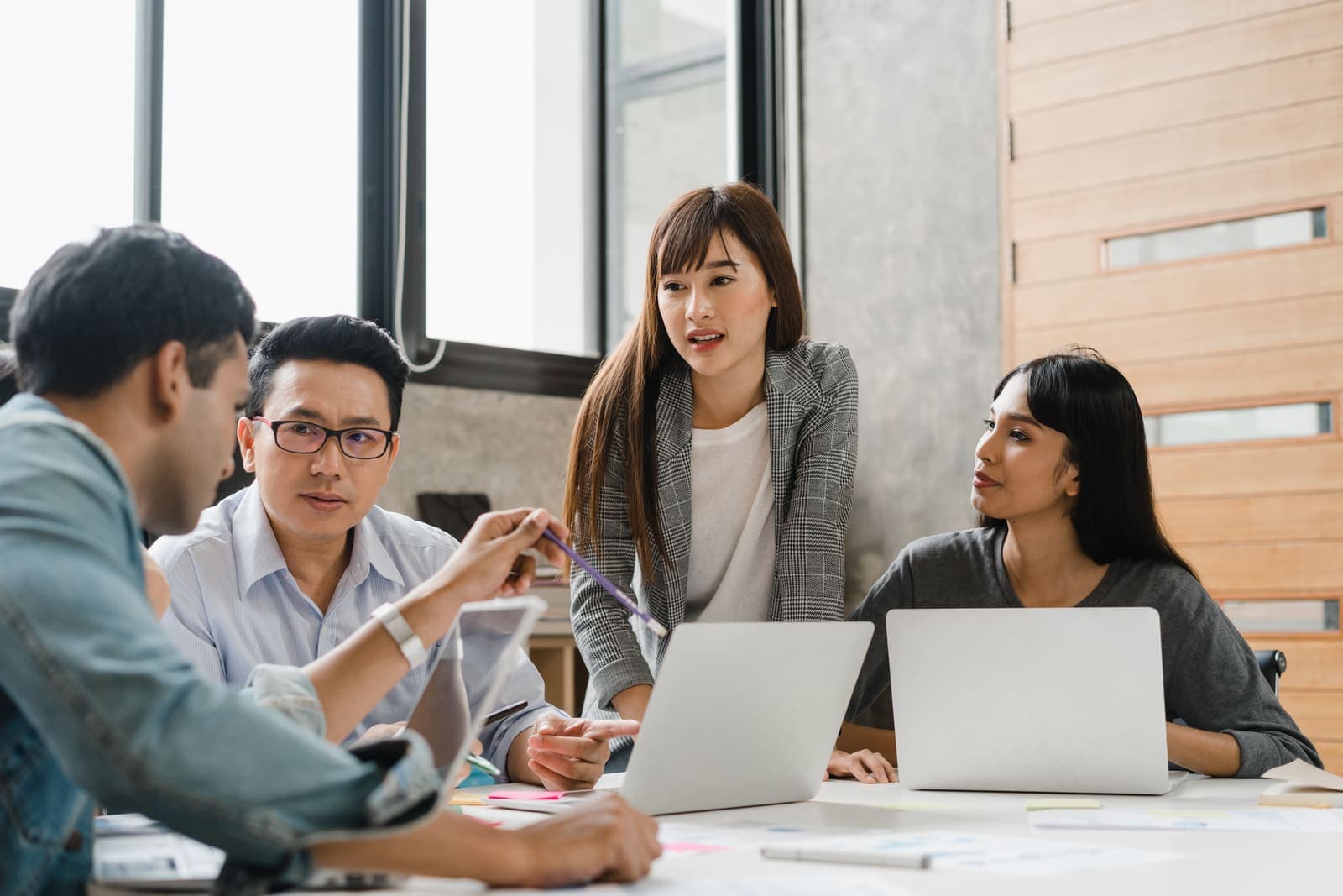 Small business team planning a marketing campaign together around a laptop