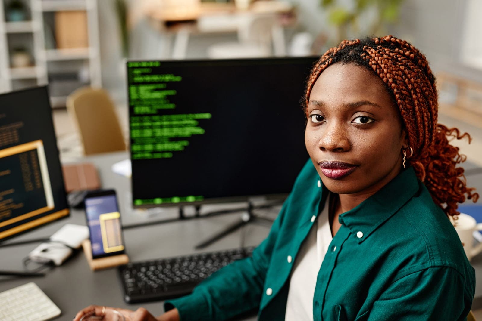 A software developer writing code at her workstation
