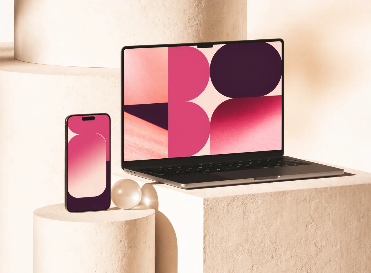 Illustrative laptop and phone concept in cream and raspberry.