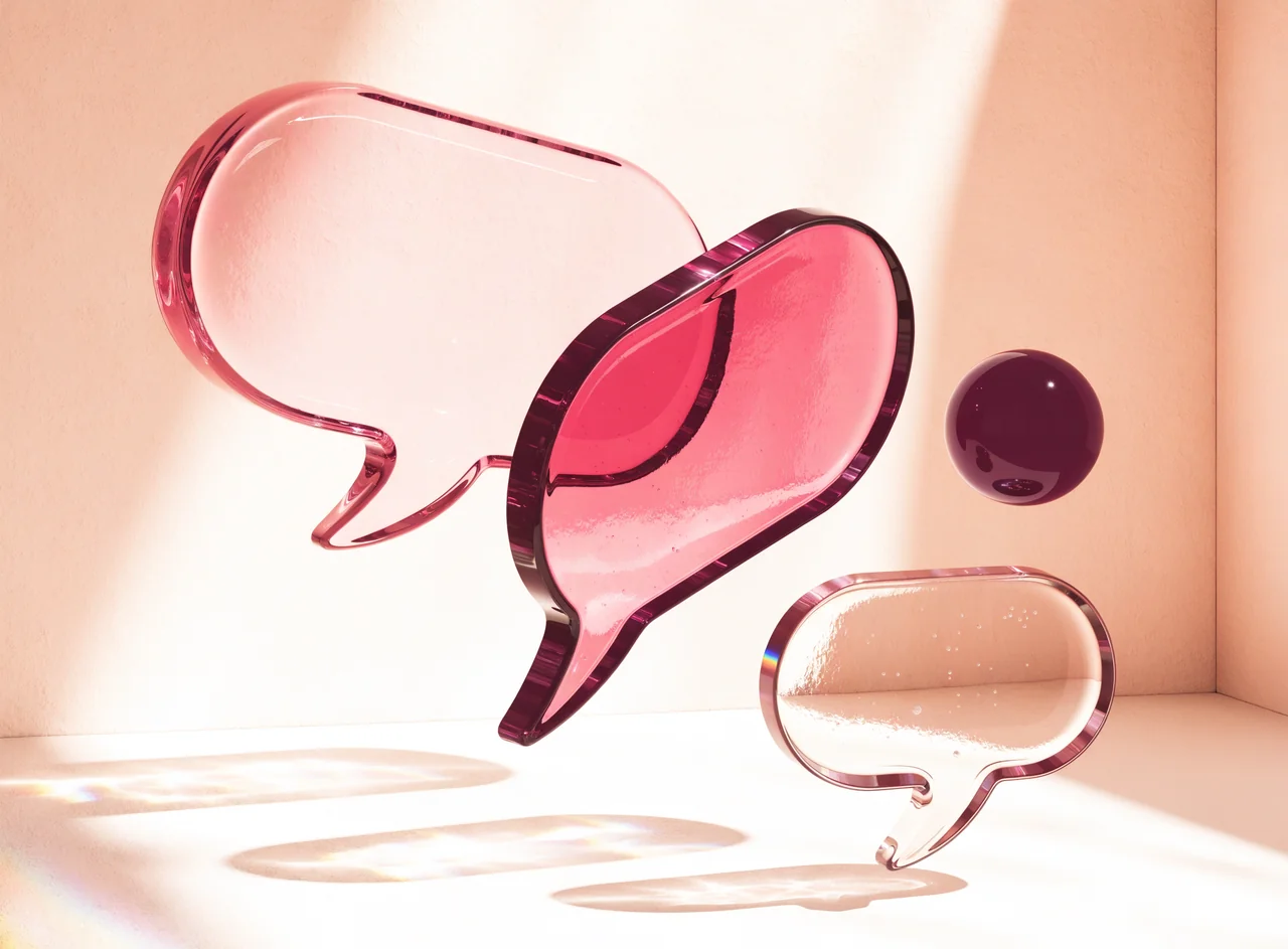 Translucent pink speech bubble sculptures above an ivory platform.
